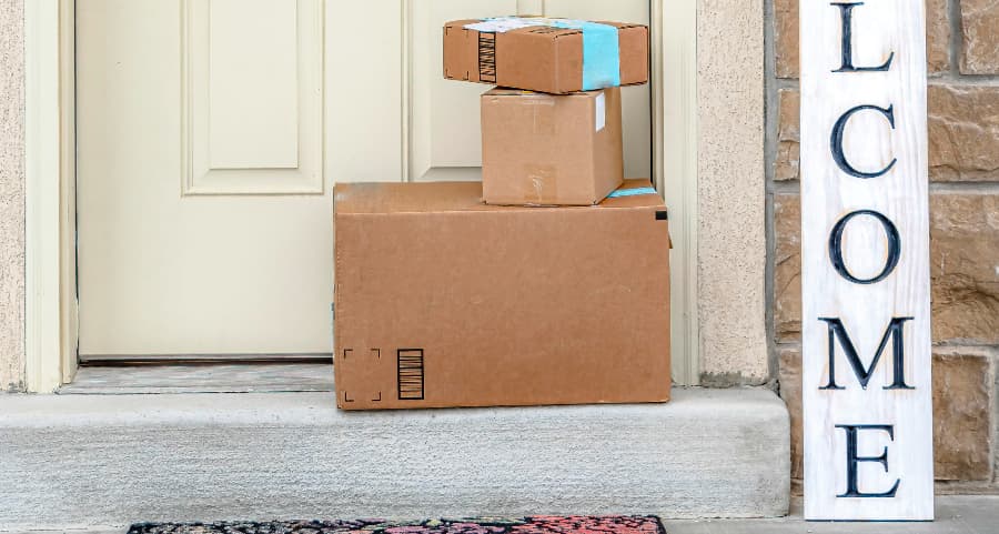 Deliveries on the front porch of a house with a welcome sign in Modesto